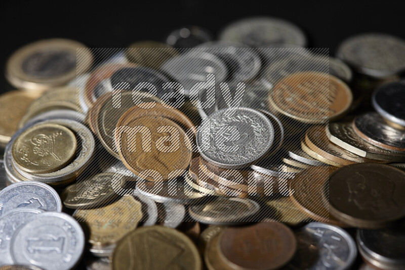 A close-ups of random old coins on black background