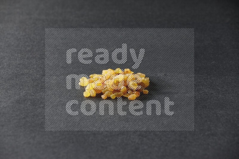 Yellow raisins isolated on a black background in different angles