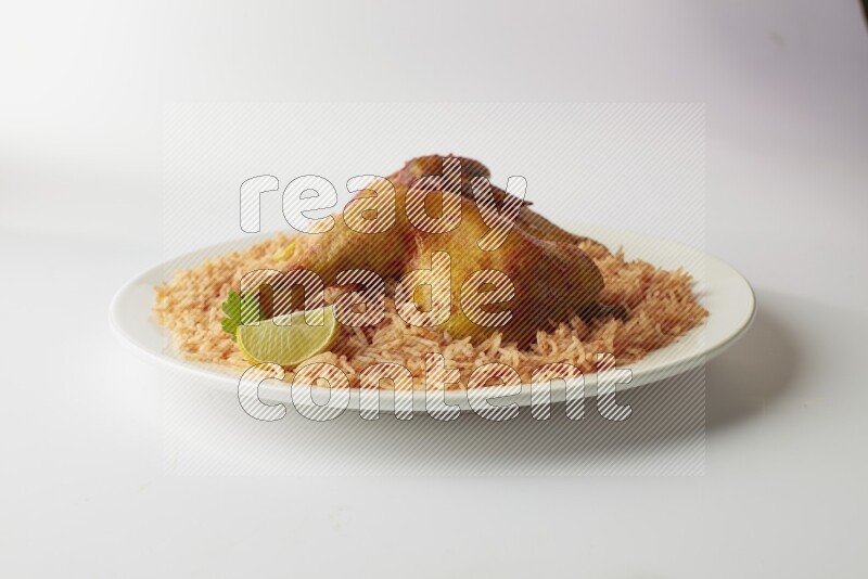 red basmati Rice with kabsa chicken pieces on a white rounded plate direct on white background