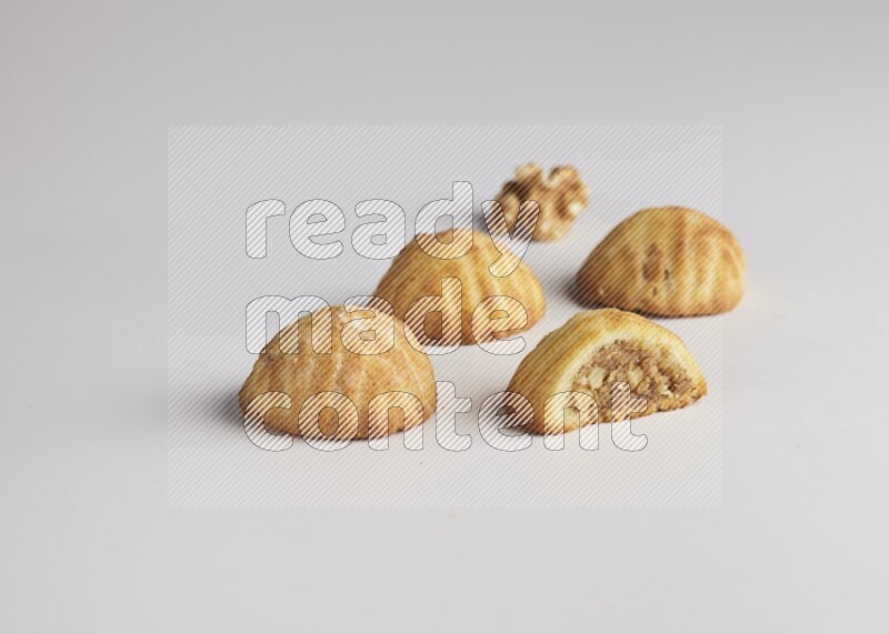 Four Pieces of Maamoul filled with walnut paste  one of them is cut direct on white background