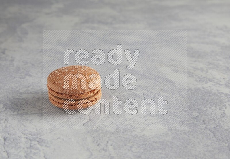 45º Shot of Brown Hazelnuts macaron on white  marble background