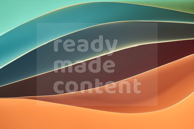 This image showcases an abstract paper art composition with paper curves in green and orange gradients created by colored light