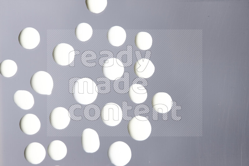 Close-ups of abstract white paint droplets on the surface