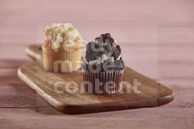 Chocolate mini cupcake topped with oreo on a wooden board