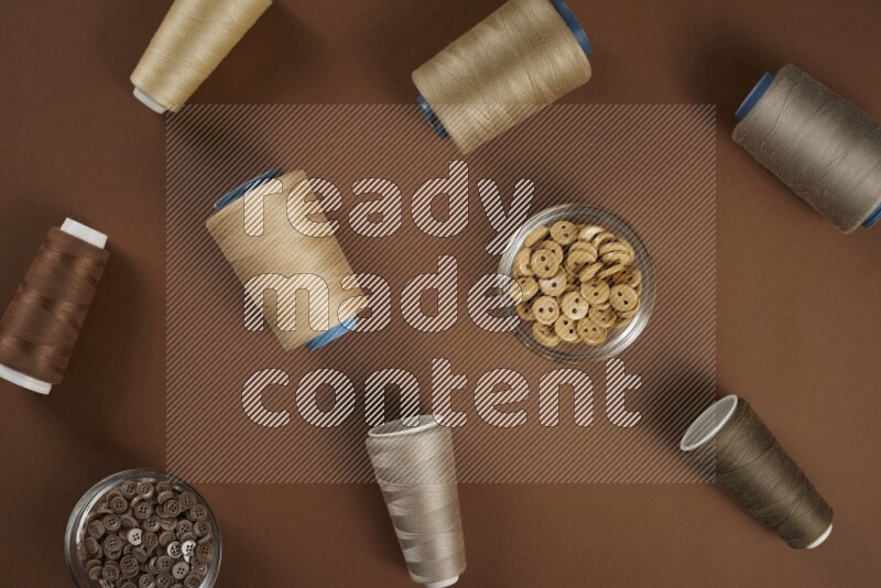 A brown collection of sewing and tailoring tools arranged on a brown background