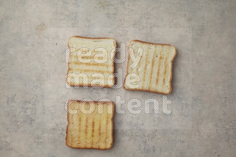 Toasted white Toast slices on a light blue textured background