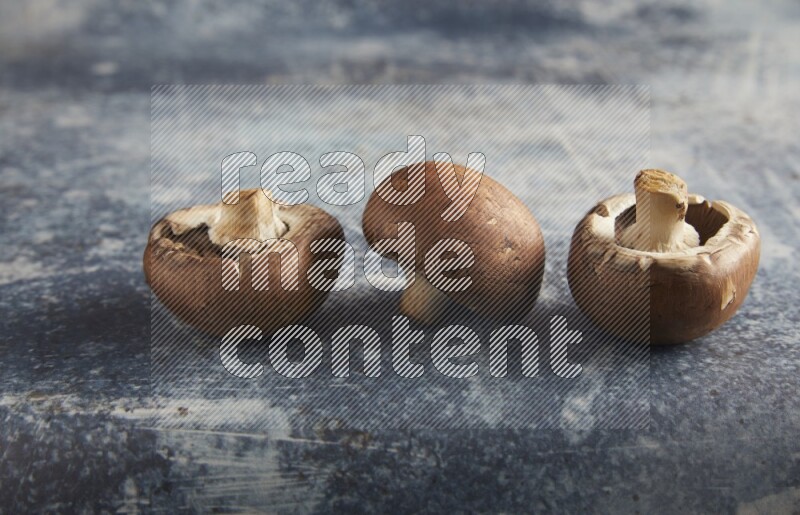 45 degre cremini  mushrooms on a textured rustic blue background