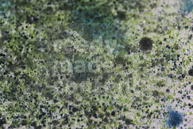 Close-ups of abstract green and blue watercolor drops on oil Surface on white background