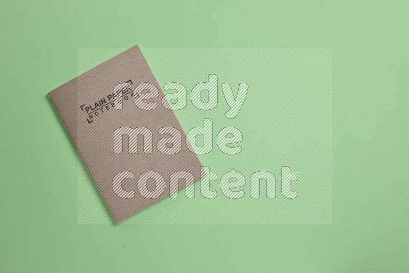 A notebook on green background