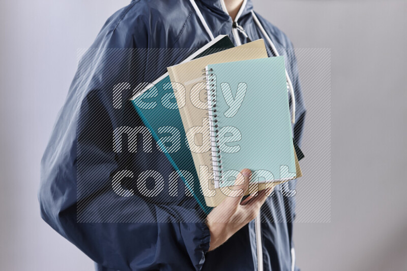 Man holding books and a board in different positions (back to school)