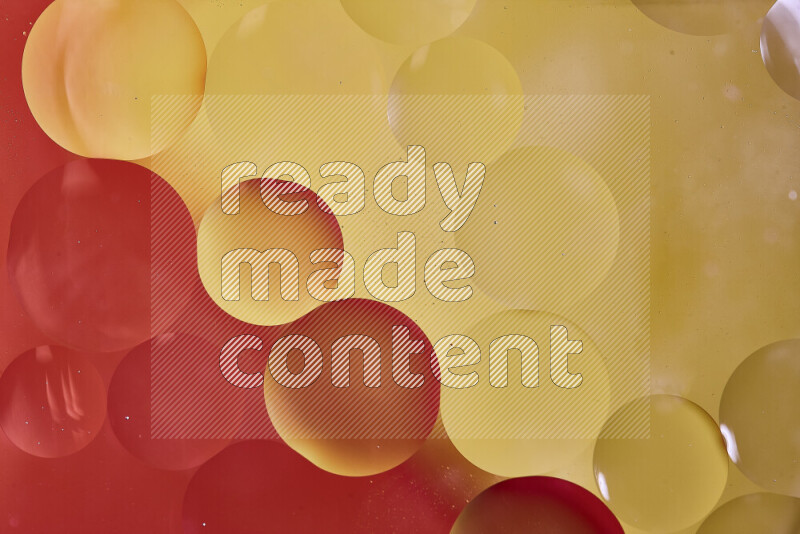 Close-ups of abstract oil bubbles on water surface in shades of red and yellow