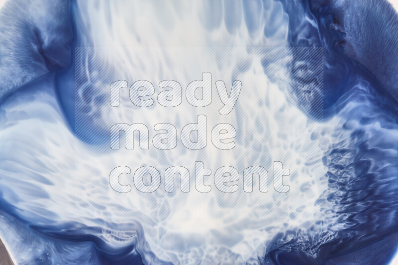 A close-up of abstract swirling patterns in blue and white