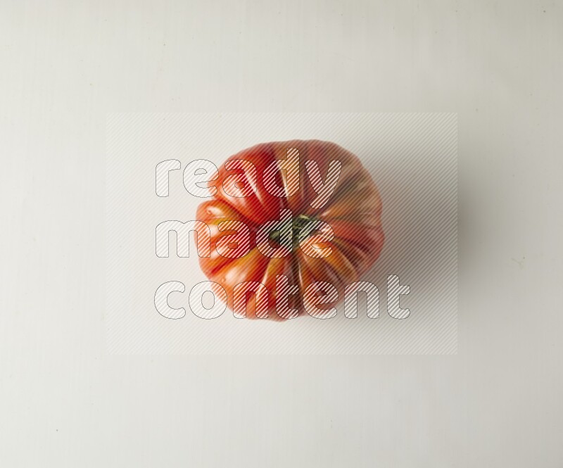 Single topview Heirloom tomato on a white backgrounds