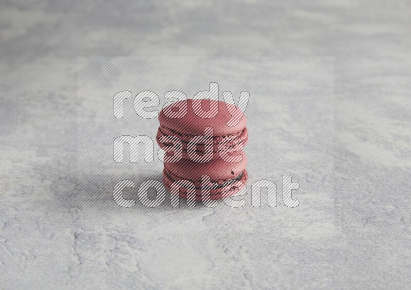 45º Shot of two Red Cherry macarons  on white  marble background