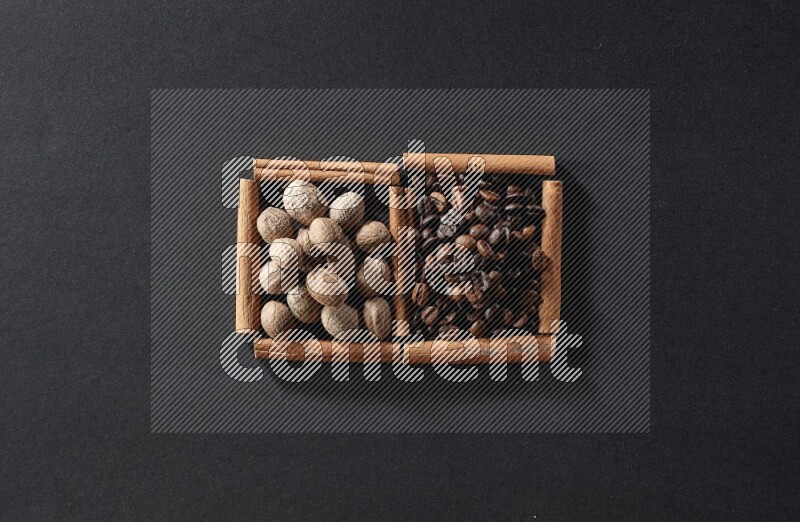 2 squares of cinnamon sticks full of coffee beans and nutmeg on black flooring