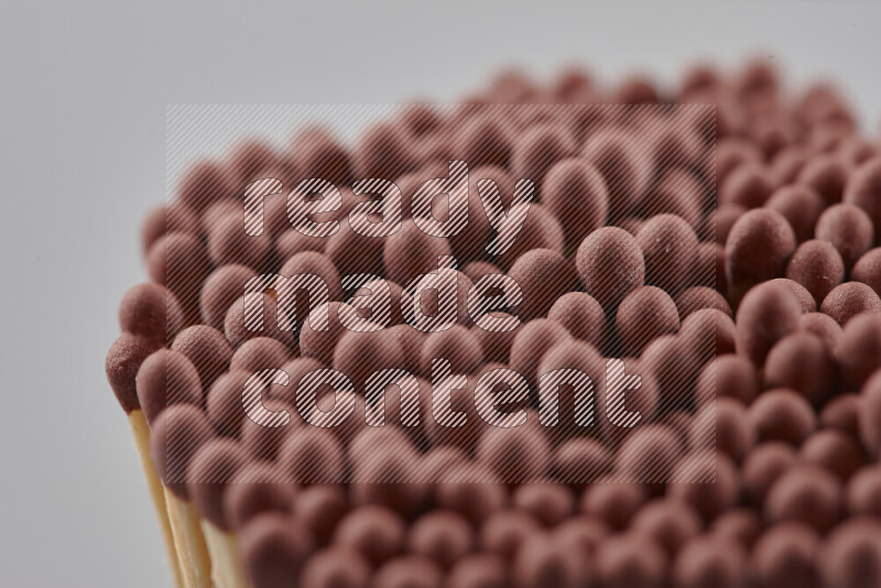 A close-up of a bundle of matches on grey background