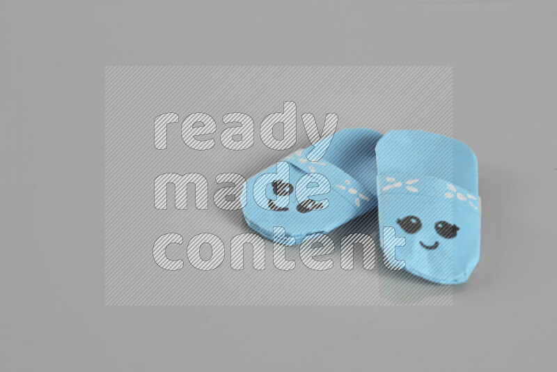 Origami slippers on grey background