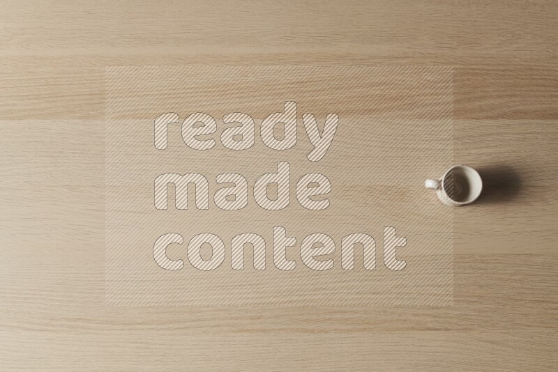 A pottery cup on light wooden background