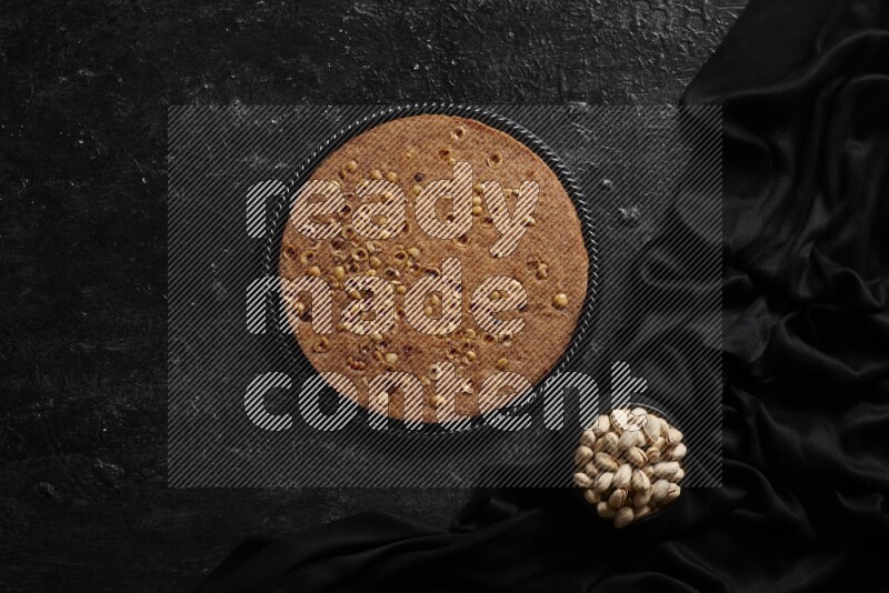Basbousa with nuts and honey in a dark setup