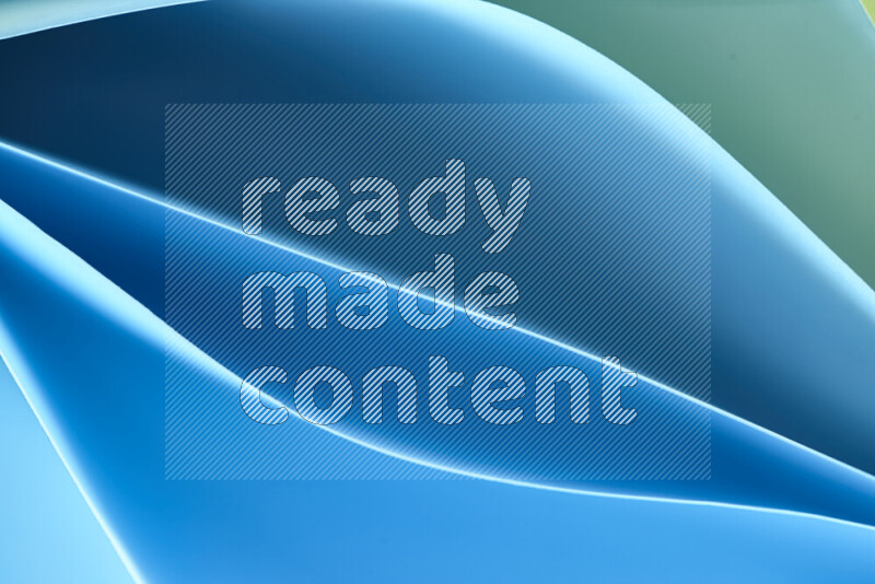 This image showcases an abstract paper art composition with paper curves in green and blue gradients created by colored light
