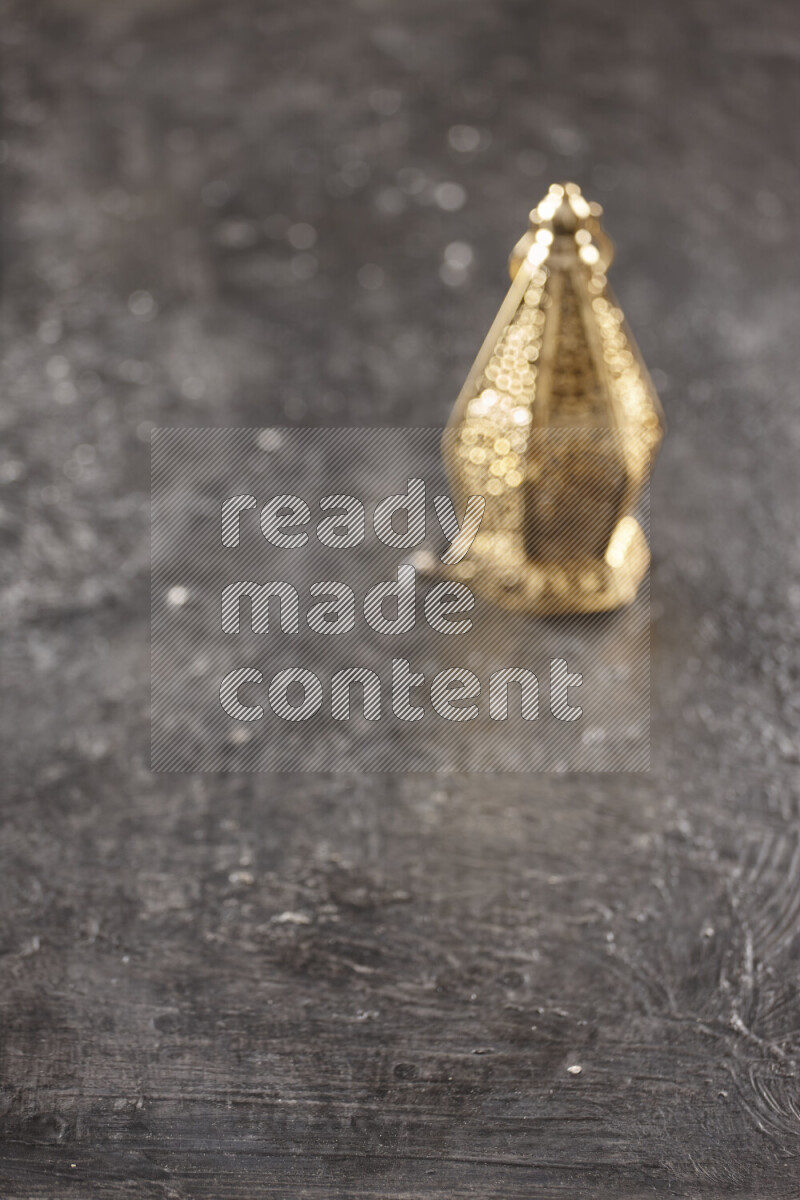 A lantern placed on a textured black background