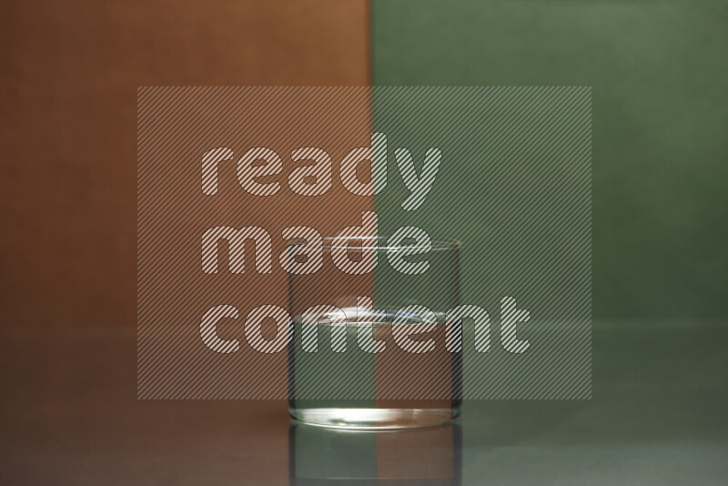 The image features a clear glassware filled with water, set against brown and dark green background
