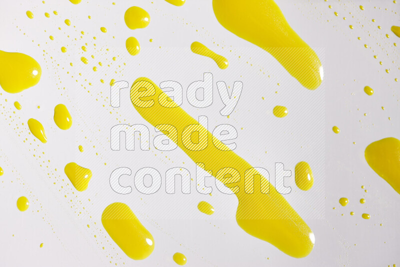 Close-ups of abstract yellow paint droplets on white background