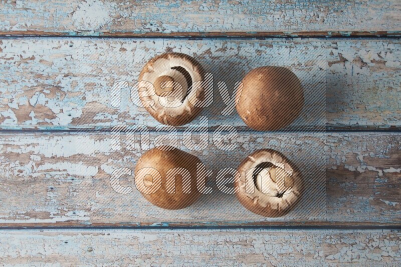 small fresh Cremini mushrooms topview on wooden blue background