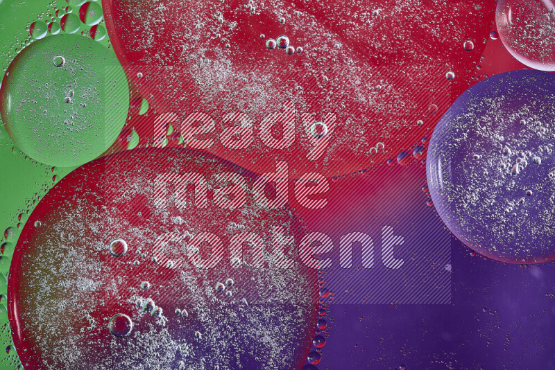 Close-ups of abstract oil bubbles on water surface in shades of purple, green and red