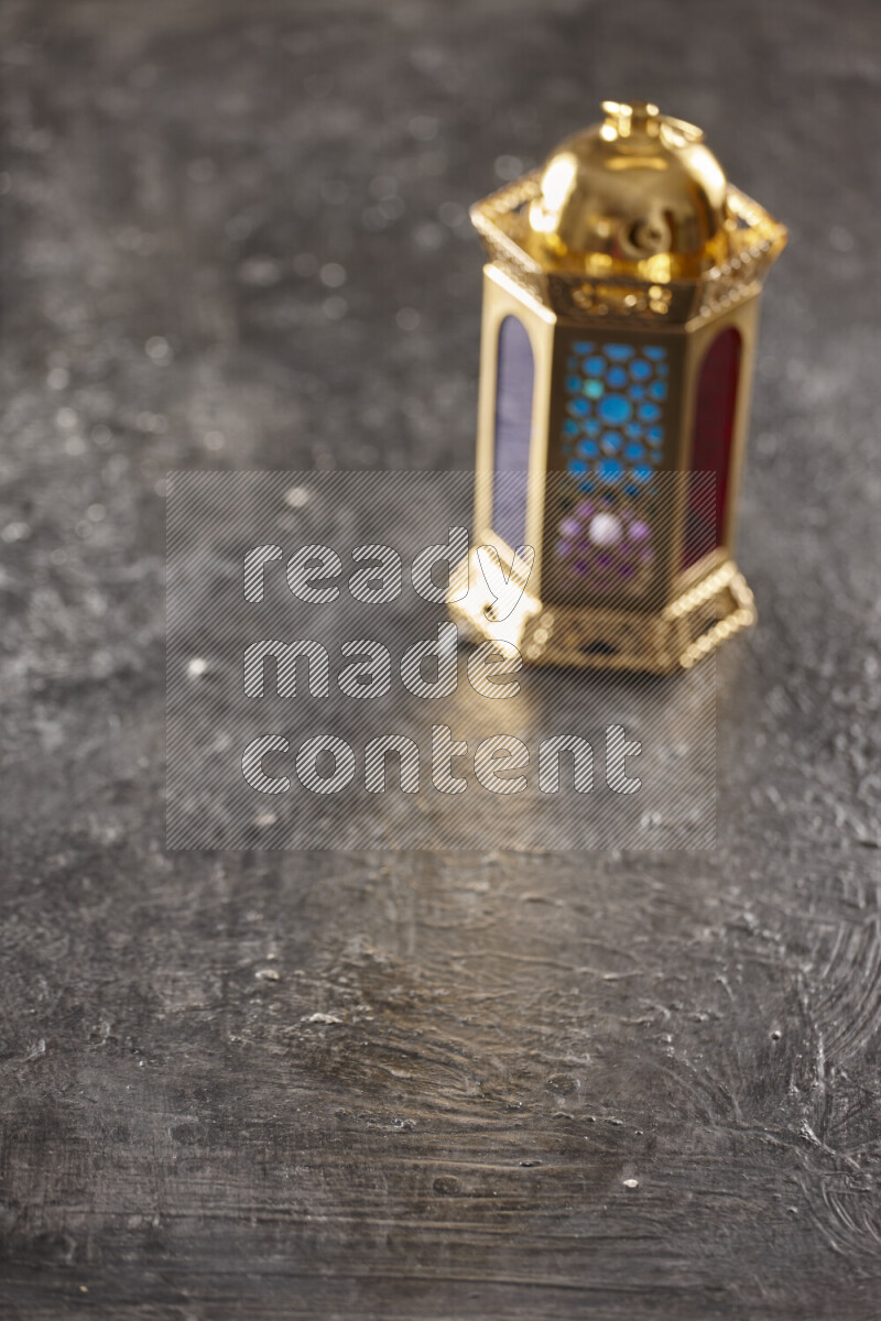 A lantern placed on a textured black background