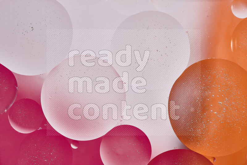 Close-ups of abstract oil bubbles on water surface in shades of white, orange and pink