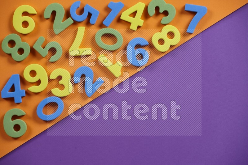 Colorful foam numbers for kids on orange and purple background (kids toys)