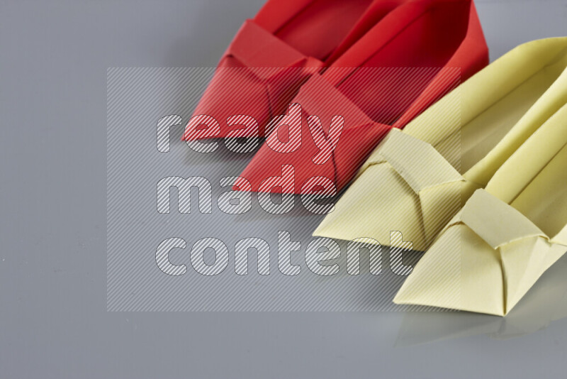 Origami shoes on grey background