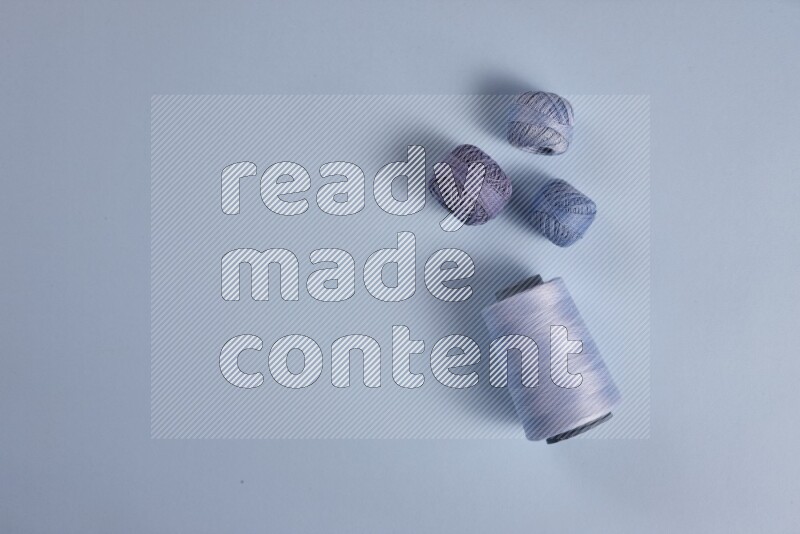 A blue collection of sewing and tailoring tools arranged on a blue background