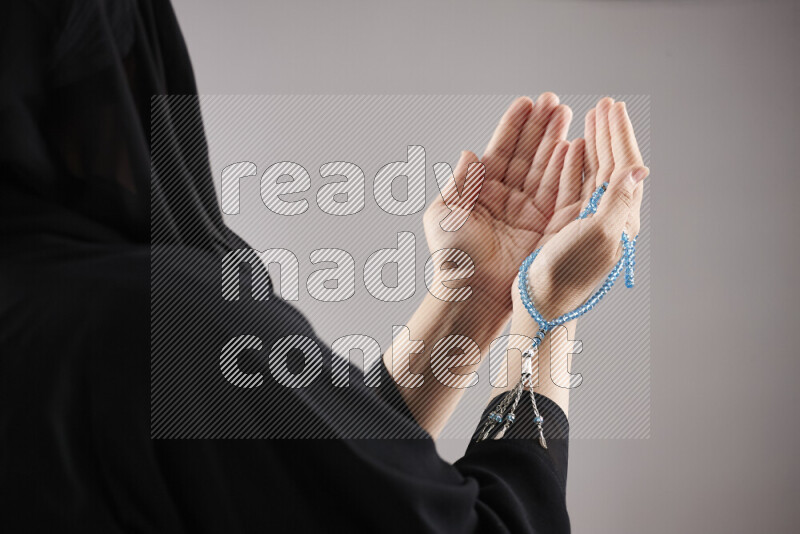 Woman hands holding praying beads (sebha) in different positions