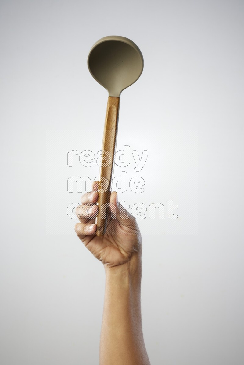 Male Hand Holding ladle on white background