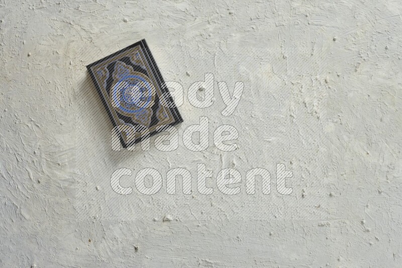 Quran with a prayer beads on white background