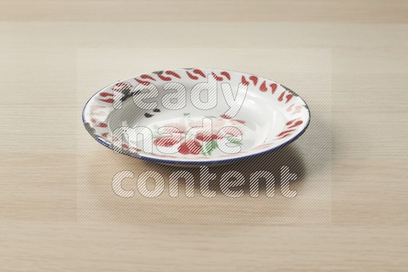 A vintage metal plate on light wooden background