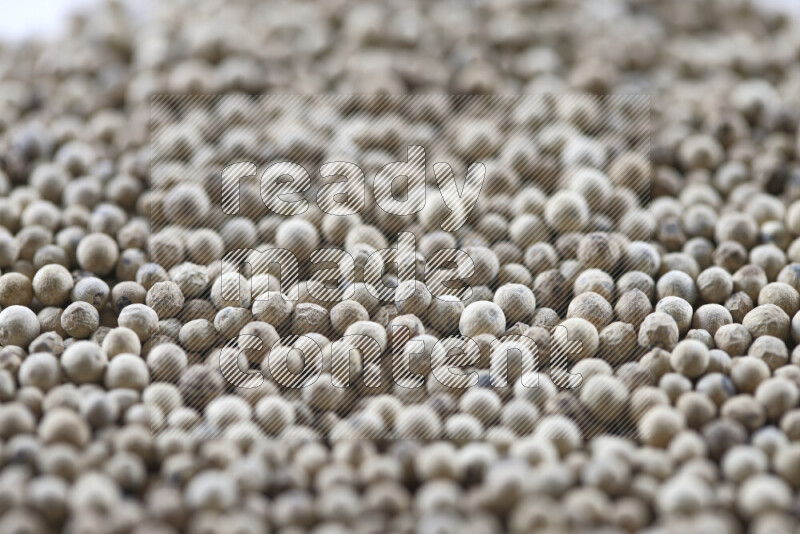 White pepper beads on white background