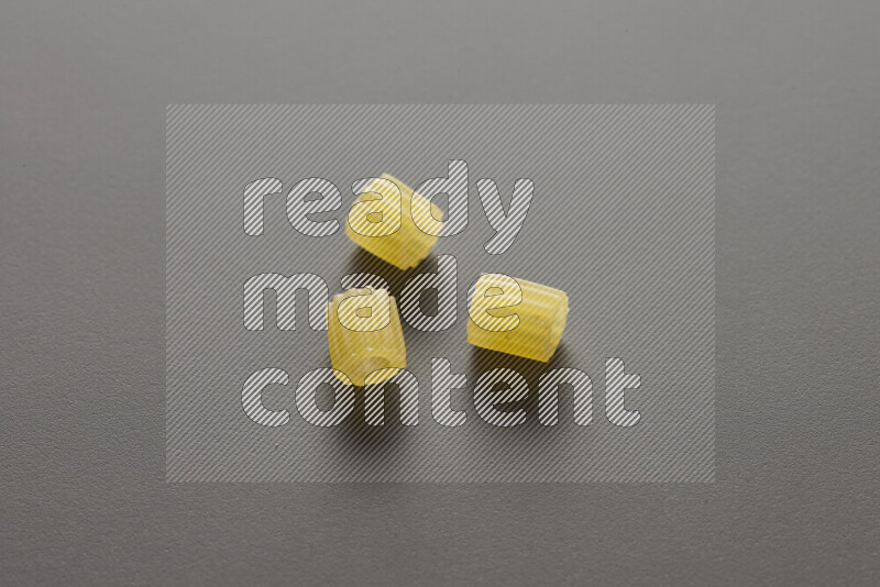 Small rings pasta on grey background