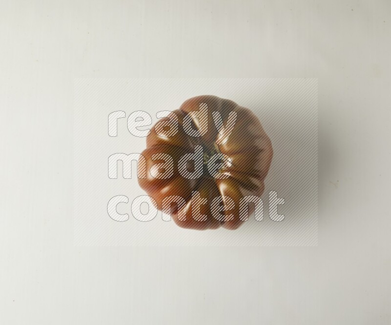 Single topview Heirloom tomato on a white backgrounds