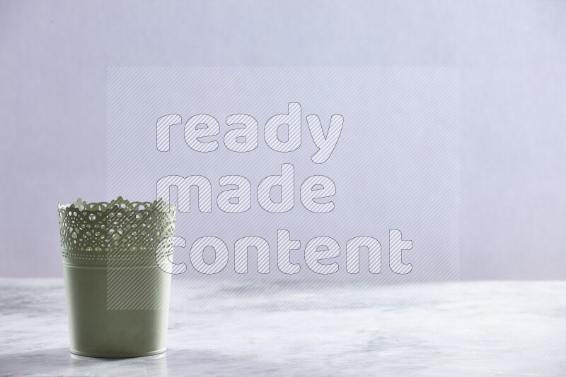 An empty green plant pot on grey marble background