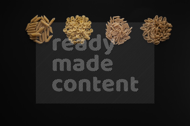 Different pasta types in 4 bunches on black background