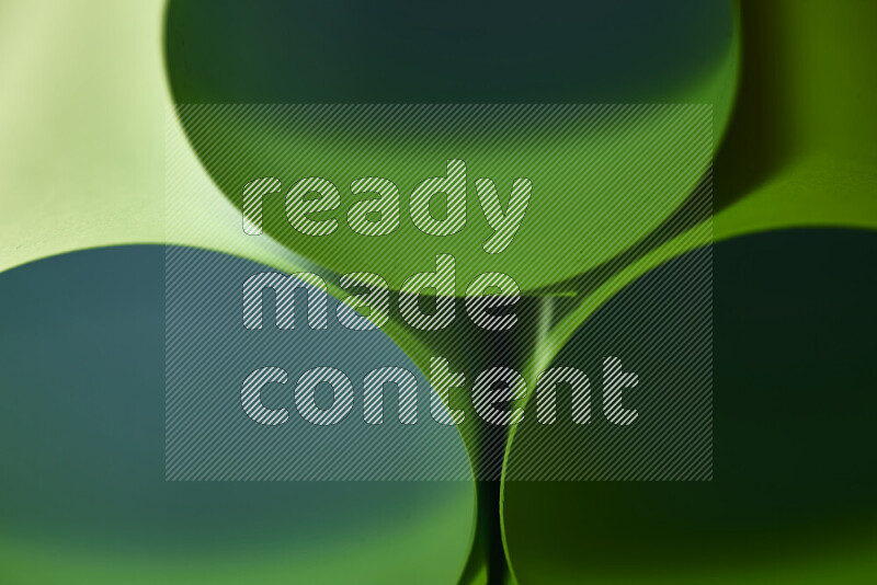 The image shows an abstract paper art with circular shapes in varying shades of green