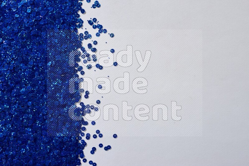 Multicolored flat sequins on grey background
