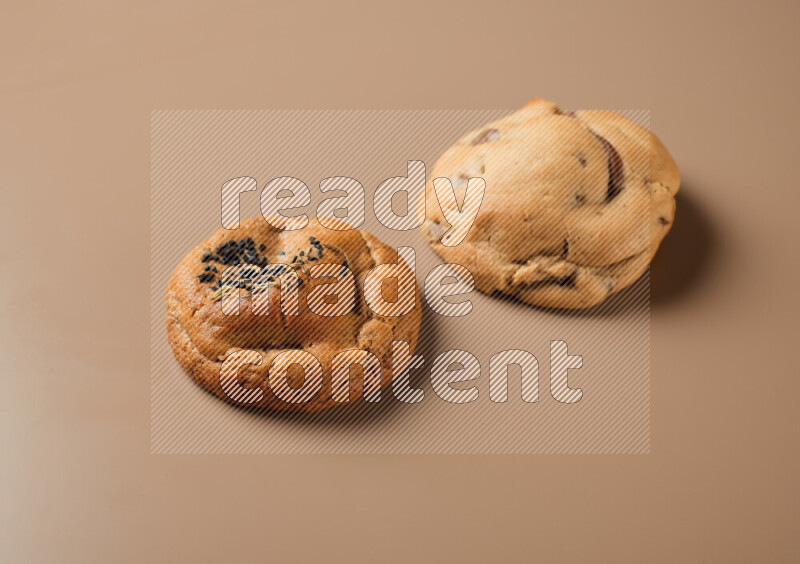 Two piece of mixed cookies on a brown background