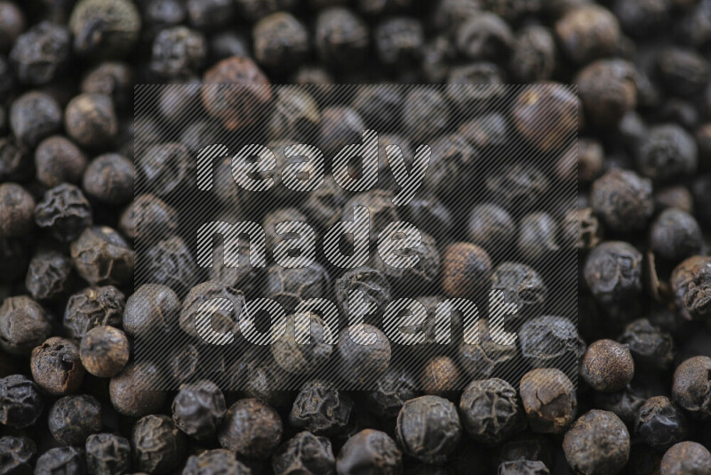 Black pepper beads on white background