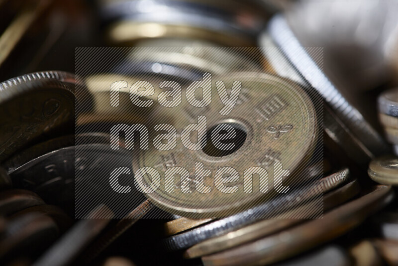 A close-ups of random old coins on black background