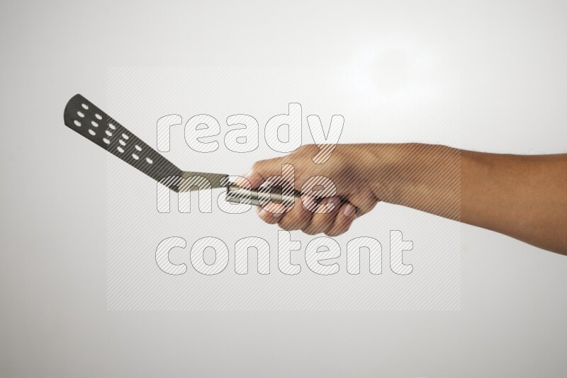 Male Hand Holding Burger Flipper on white background