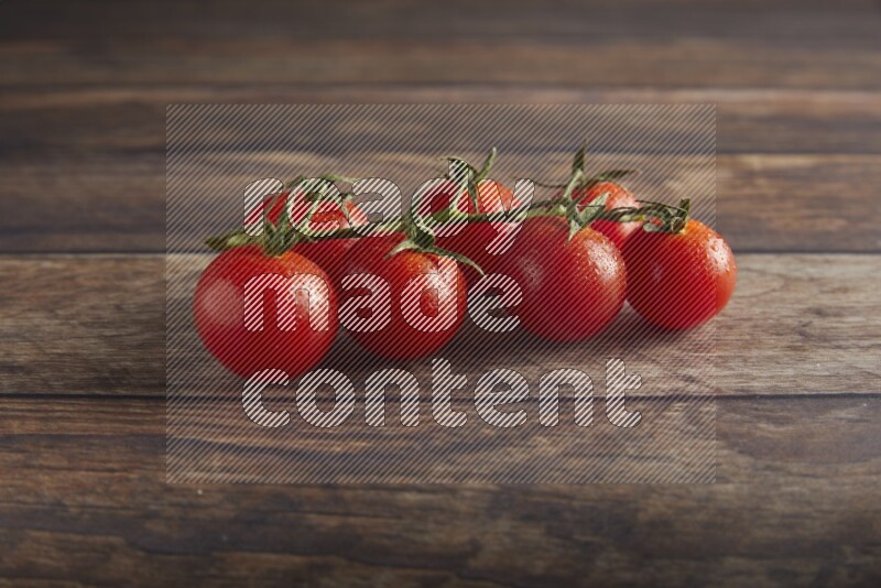 Red cherry tomato vein on a textured wooden background 45 degree